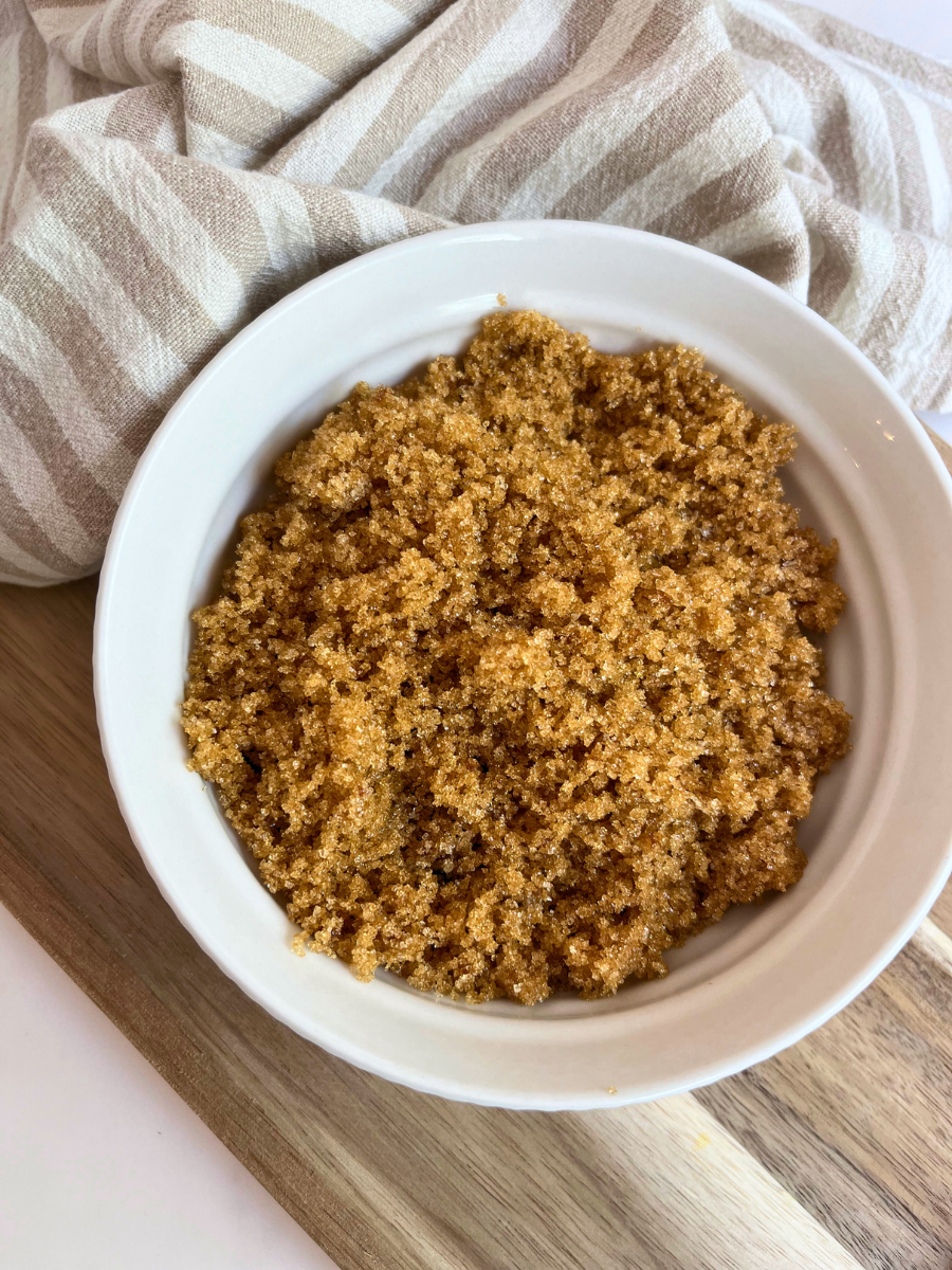 Homemade Brown Sugar in a white bowl with a brown and white striped towel around it