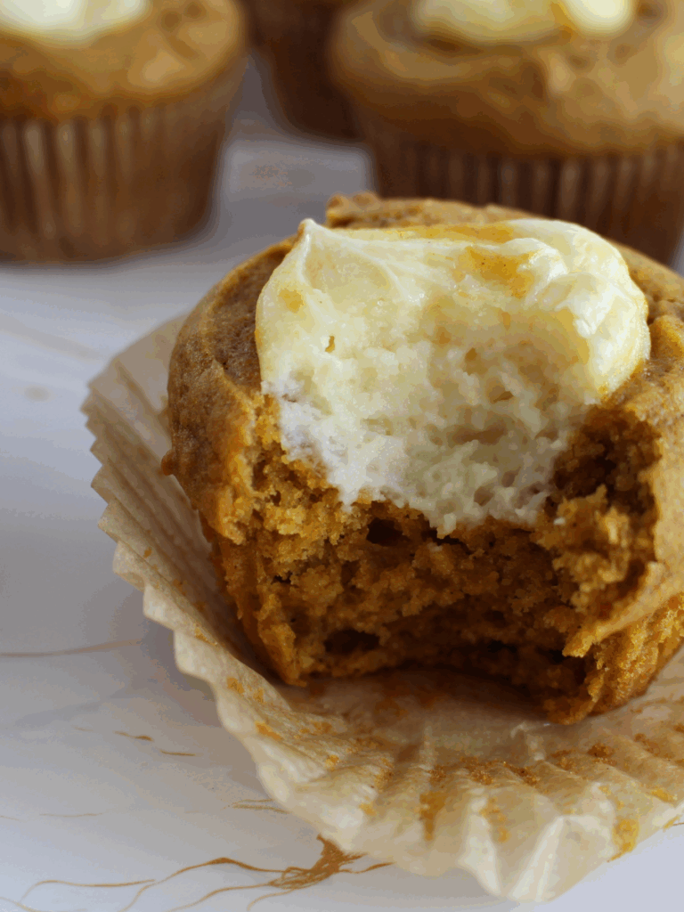 Sourdough Pumpkin Cream Cheese Muffin with a bite taken out
