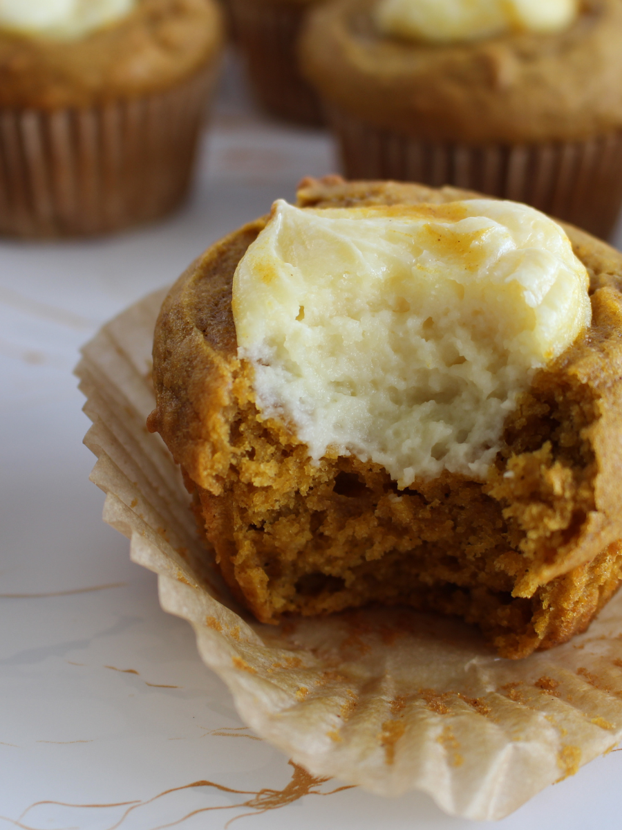 Sourdough Pumpkin Cream Cheese Muffin with a bite taken out